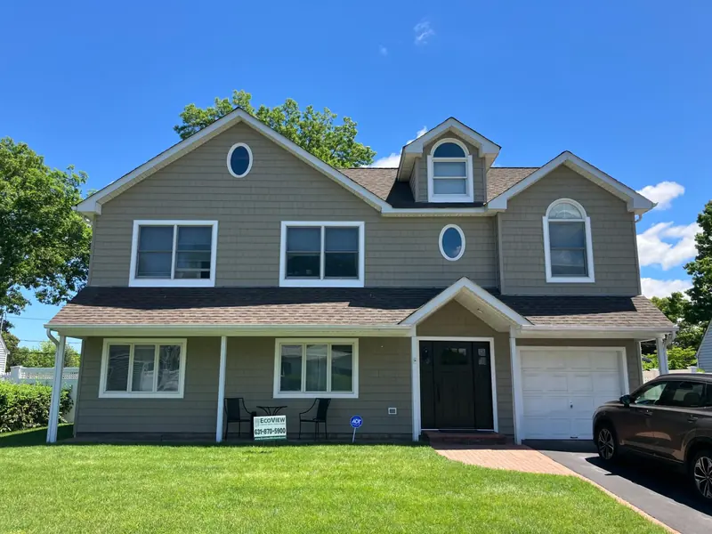 Replacement windows & new siding on a Long Island home